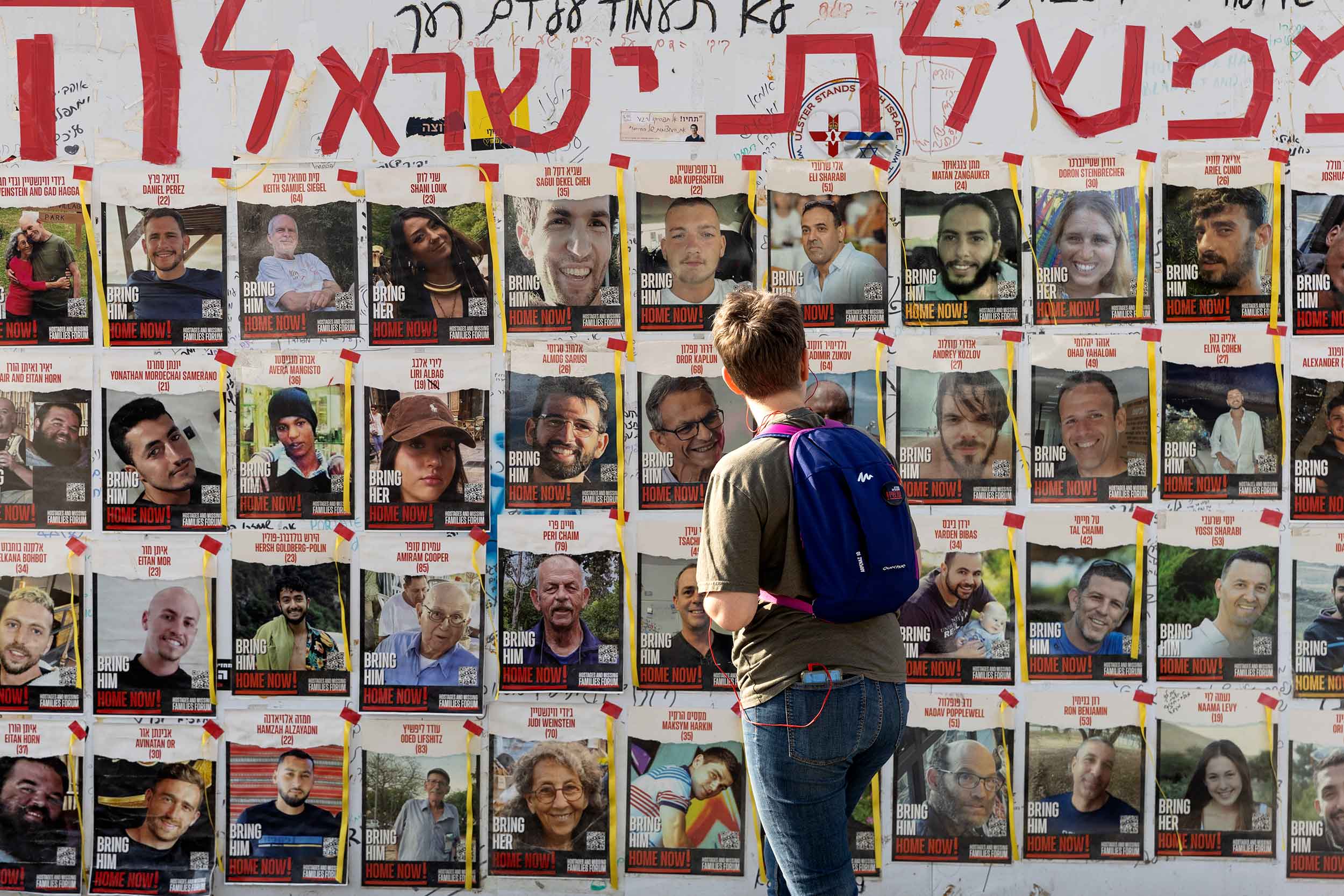 A woman looks at photos of hostages held by Hamas in the Gaza Strip covering a wall on May 01, 2024 in Tel Aviv, Israel. Israel's war cabinet convened today as the country continued to prepare for an anticipated offensive in Rafah, the southernmost city in Gaza. © Amir Levy/Getty Images