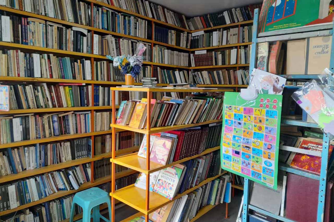 Books are cramped in the small space of the library in Zharbash. Chronic underfunding threatens rural libraries, which are critical for small communities. Advocates maintain that authorities should supply rural facilities with children's books in Kyrgyz language. © IWPR Central Asia