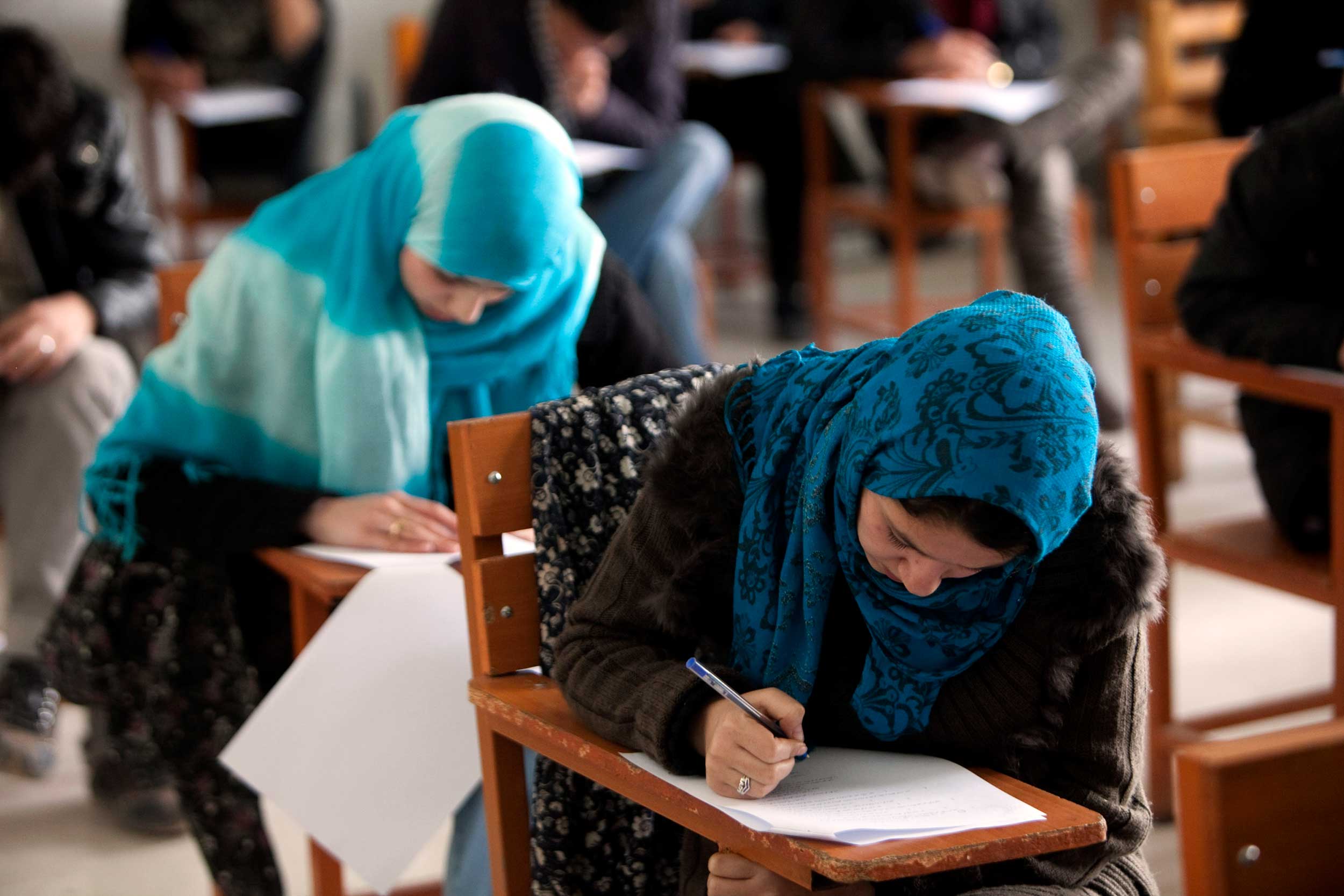 Photograph from 2010 with Afghan female students attending a lecture at Kabul University. Since the Taleban returned to power women had to quit jobs and young girls after the age of 12 can no longer go to school or complete further education. © Majid Saeedi/Getty Images