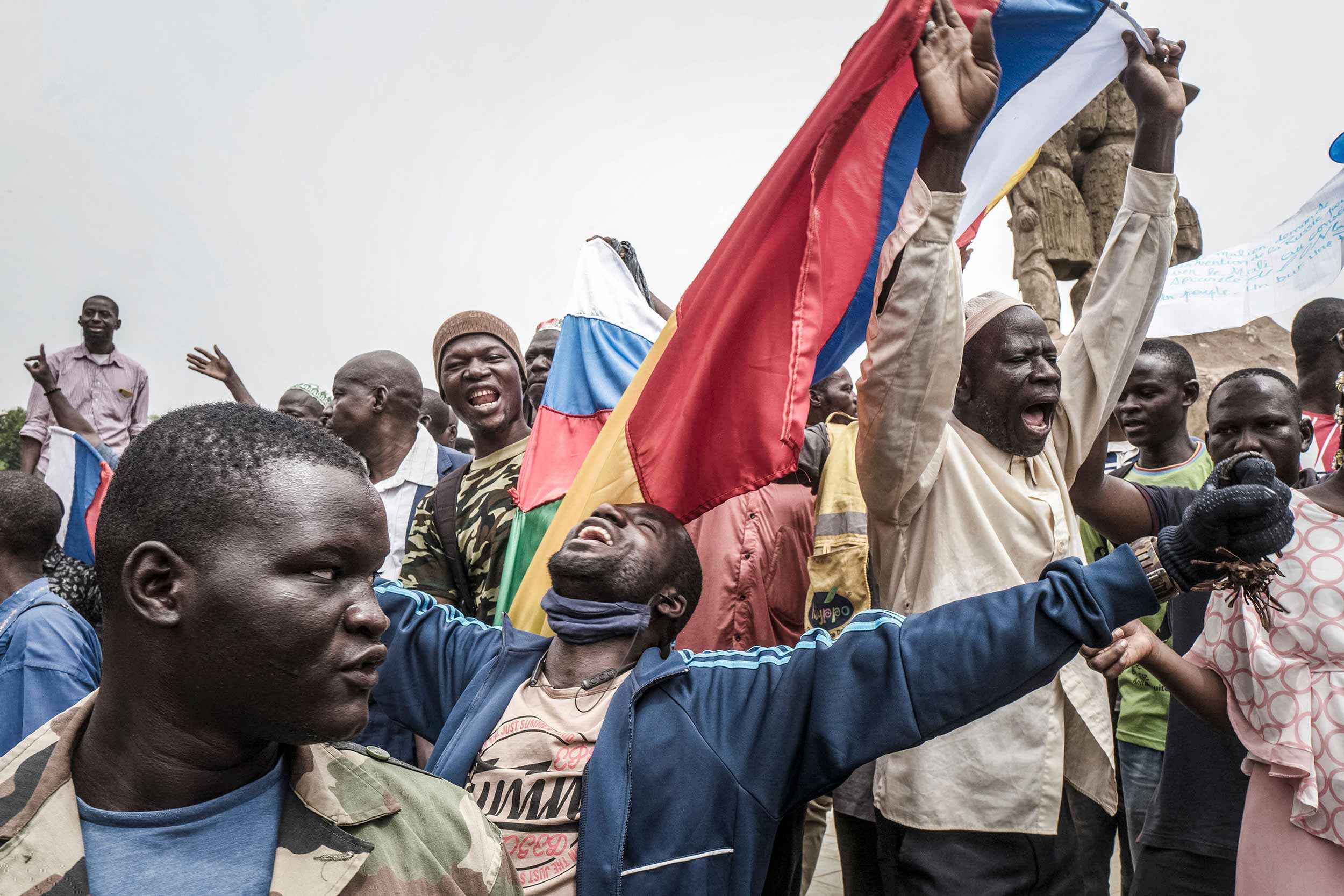 Russians and Malian flags are waved by protesters in Bamako, during a demonstration against French influence in the country on May 27, 2021. - The Malian soldiers released the Malian president and the transitional Prime Minister, while taking back the controls in their hands, far from the international demand for a rapid return of civilians to the head of the country. © Michele Cattani/AFP via Getty Images