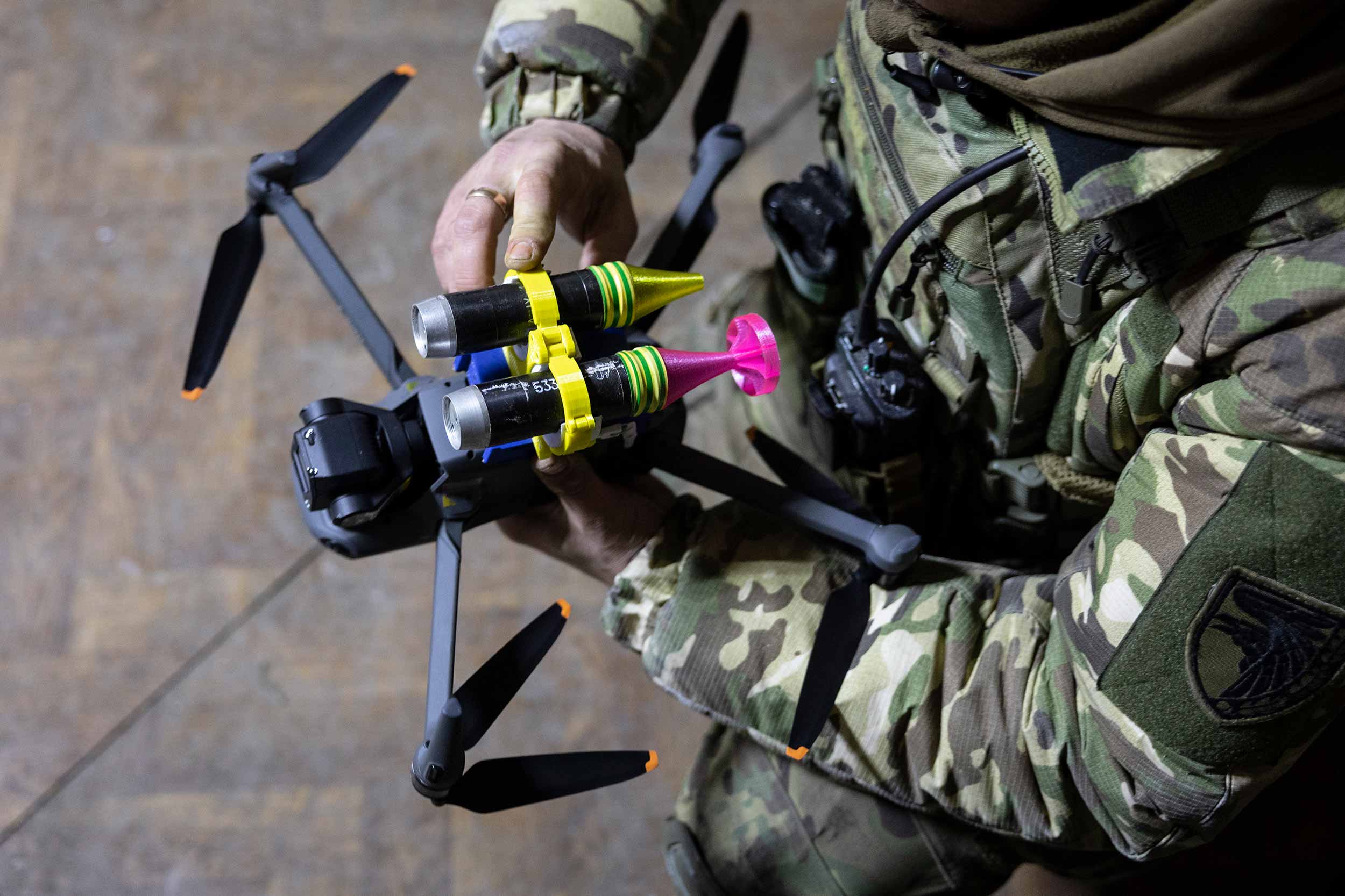 A drone operator with the Ukrainian Army's 93rd Brigade attaches grenades to a drone 3 in Bakhmut, Ukraine. Ukrainian forces have been using drones for traditional reconnaissance and directing artillery fire but have also modified them to conduct direct attacks on Russian infantry. © John Moore/Getty Images