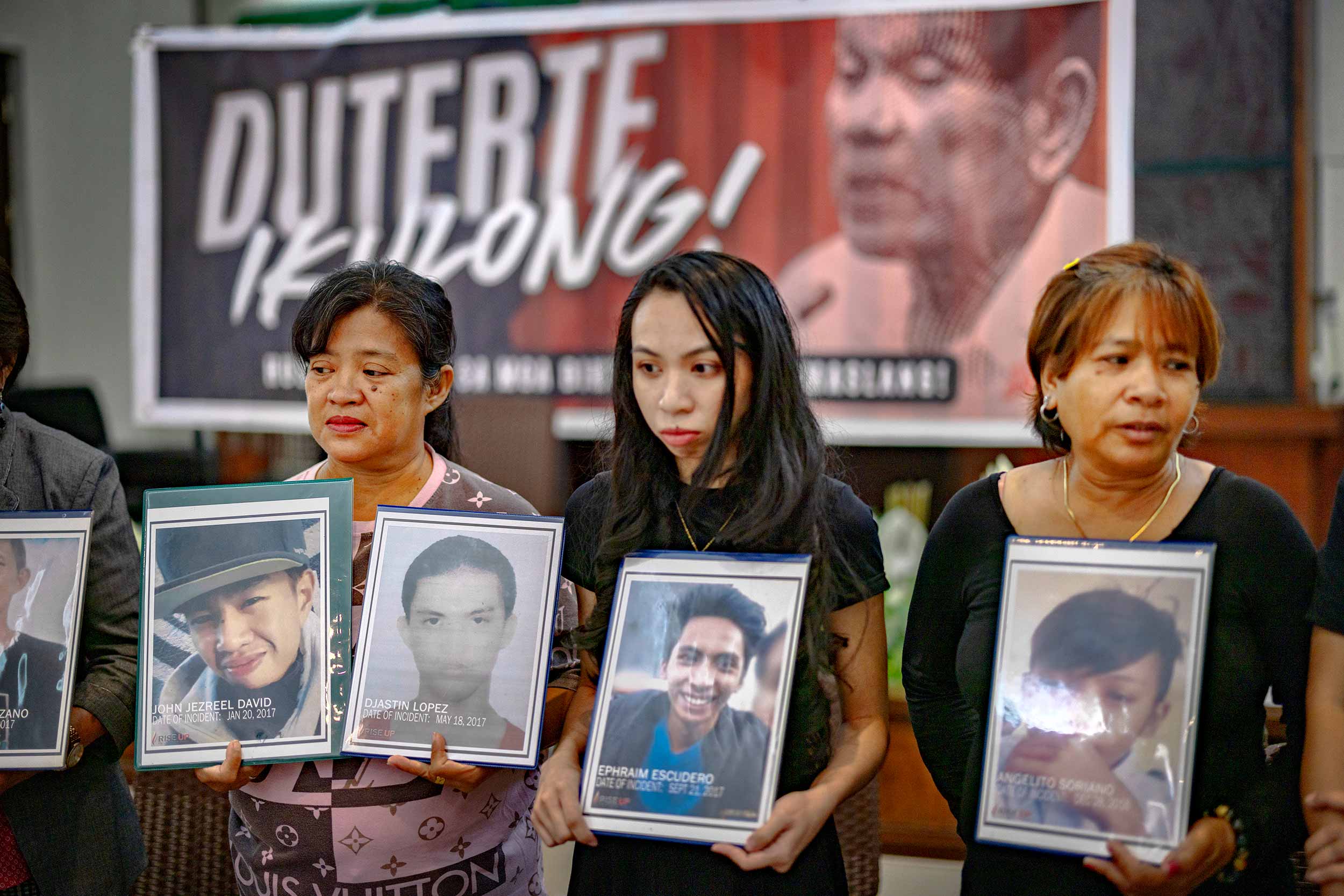 Relatives of drug war victims hold pictures of their loved ones during a gathering on March 12, 2025 in Quezon city, Metro Manila, Philippines. Former Philippines President Rodrigo Duterte was arrested at Manila airport on an International Criminal Court (ICC) warrant for alleged crimes against humanity related to his "war on drugs," which resulted in thousands of deaths during his presidency from 2016 to 2022. © Ezra Acayan/Getty Images