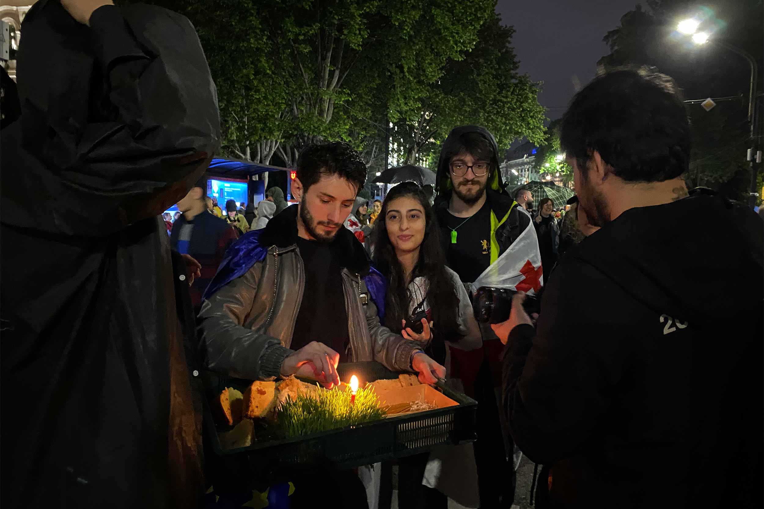 Young protesters are sharing Easter eggs and cakes for free in a symbolic act of reconciliation and mutual understanding. © Beka Bajelidze