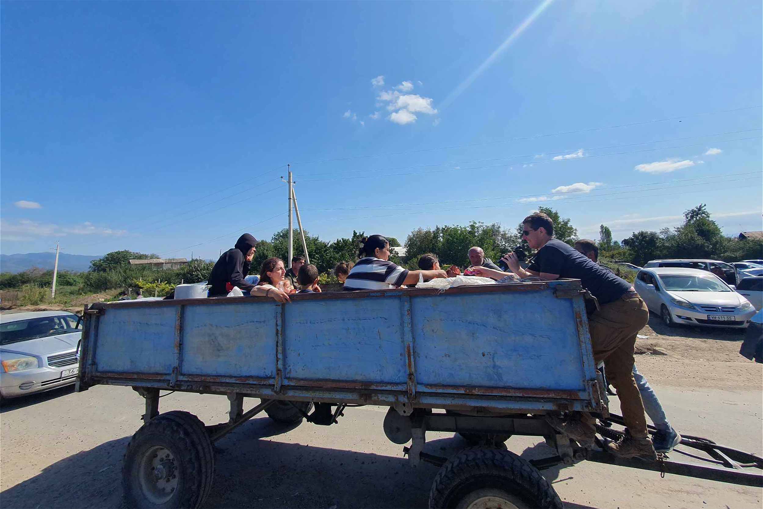 Refugees on a large trailer enter Kornidzor, a village near Goris, in eastern Armenia. People travelled on the Lachin corridor, a serpentine mountain road, which is Karabakh's critical lifeline. The road was reopened on September 24 after nearly ten months. © Arshaluis Mghdesyan 
