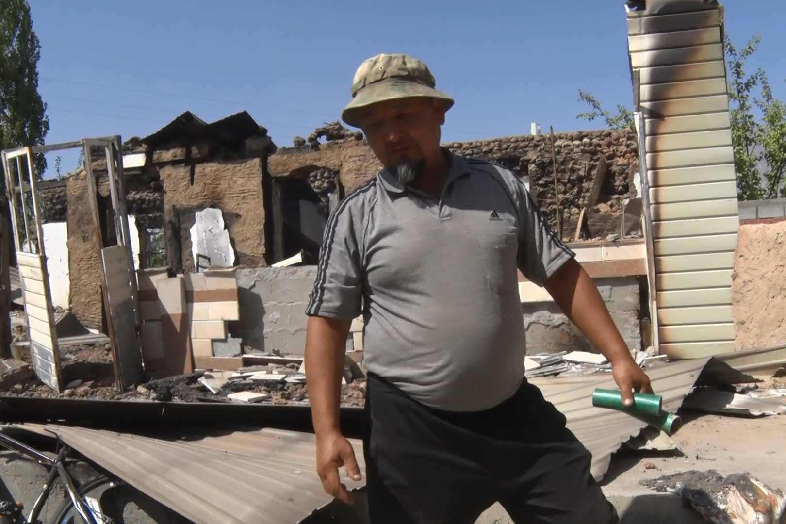 Abdirashit Kudaiberdiev stands by the ruins of his house, in Batken district’s Ak-Sai village. The Kyrgyz village is across the Tajik’s settlement of jamoat of Chorkukh. “Everything is burned, my neighbours’ houses are also destroyed…I have six children, four daughters and two sons, and two of my grandchildren left for Bishkek. I won’t take them here until I’ll build the new house,” he said. © IWPR Central Asia