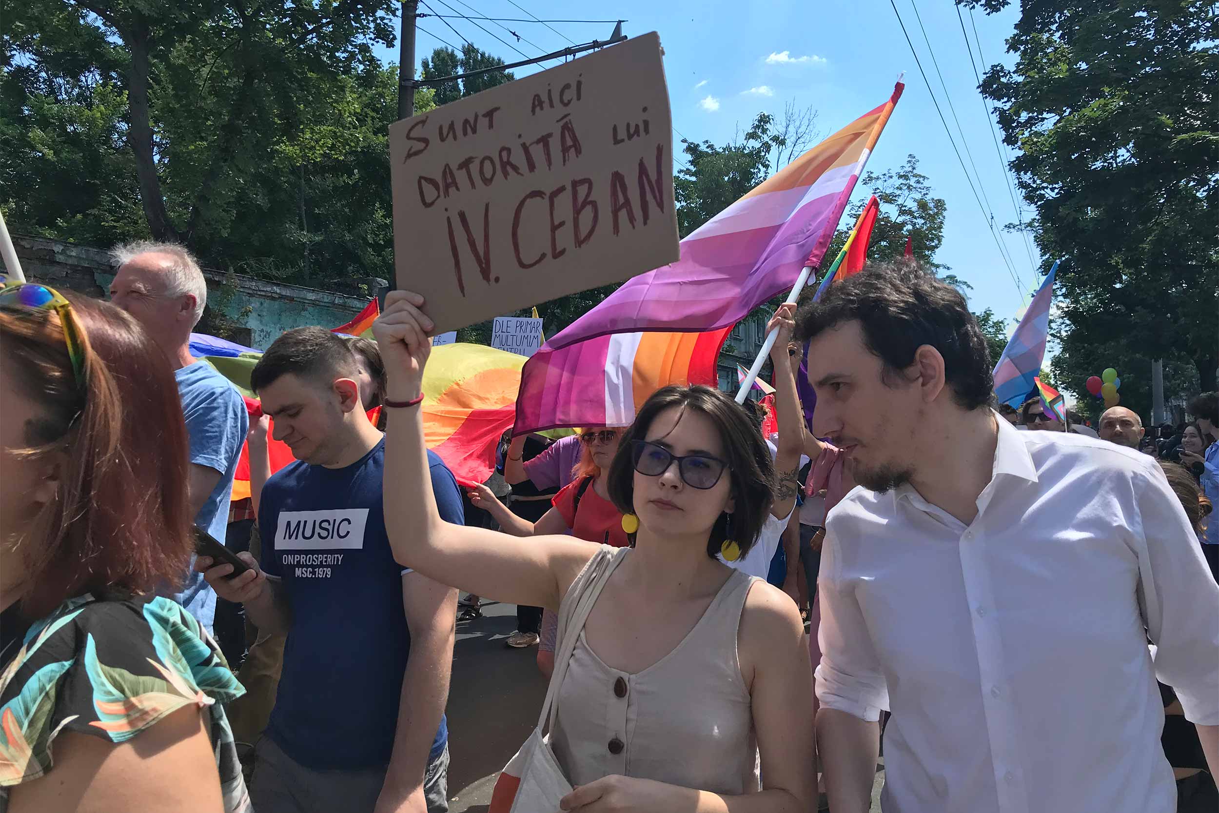 A woman holds a sign, which reads &quot;I am here because of Ion Ceban.&quot; Ceban is the mayor of Moldova's capital Chisinau, whose threats to ban the Pride march to go ahead, prompted several people to attend in support of the organisers and the LGBT+ community. © Aliona Ciurca