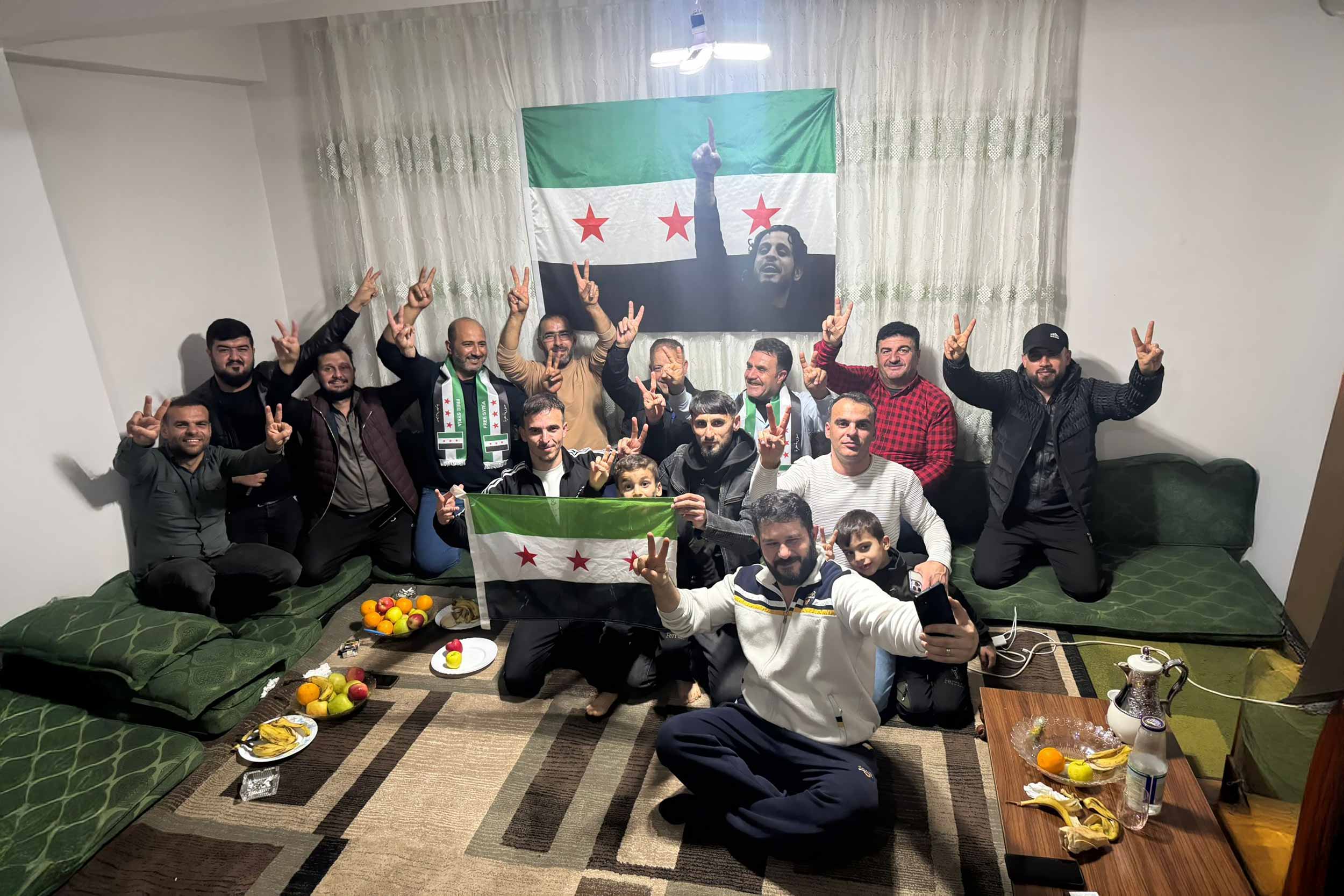 Abdulaziz Atiya (middle-right) celebrates Assad's ousting in Narlıca, a predominantly Syrian neighbourhood of Antakya, Turkey. © Burcu Günaydın