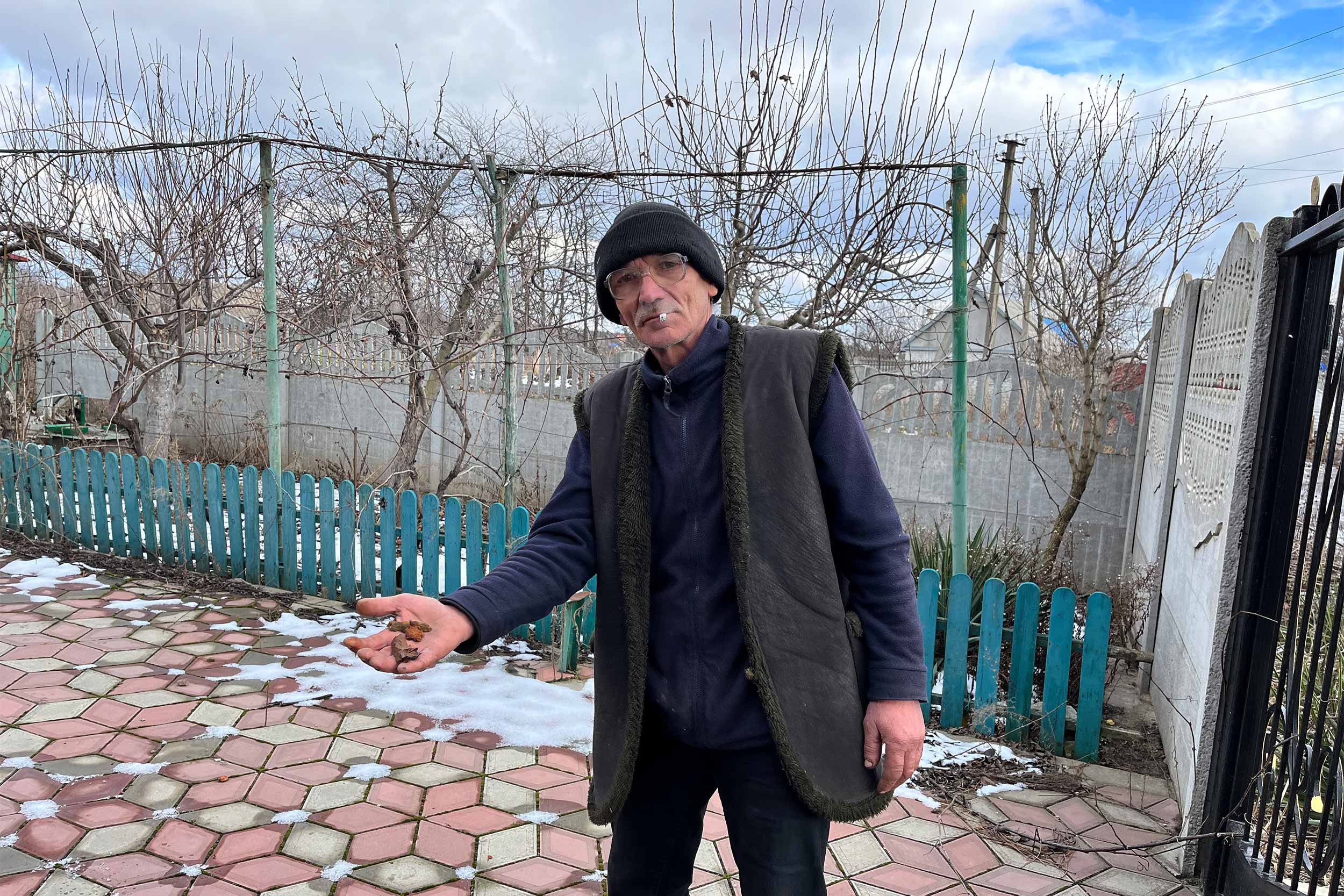 Oleksandr Lanchyk, on of the few who remaining residents in Orikhiv shows off fragments of the shell that hit his house in October, setting the house on fire. © IWPR
