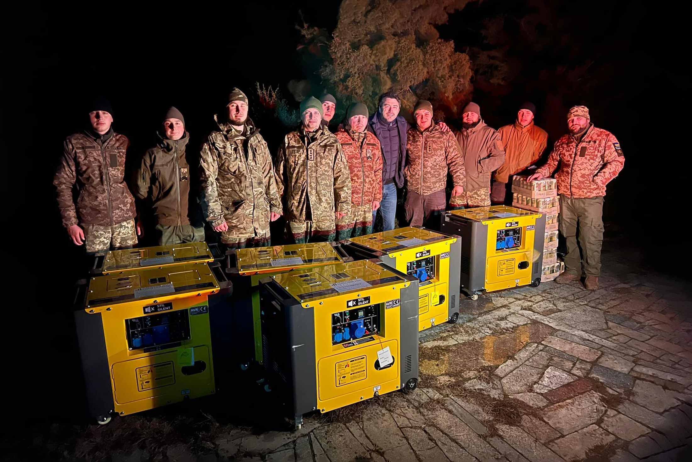 Serhiy Prytula (centre) with soldiers on the frontline in eastern Ukraine, delivering generators bought through crowdfunding coordinated by the former actor’s foundation. © Courtyesy of S. Prytula.
